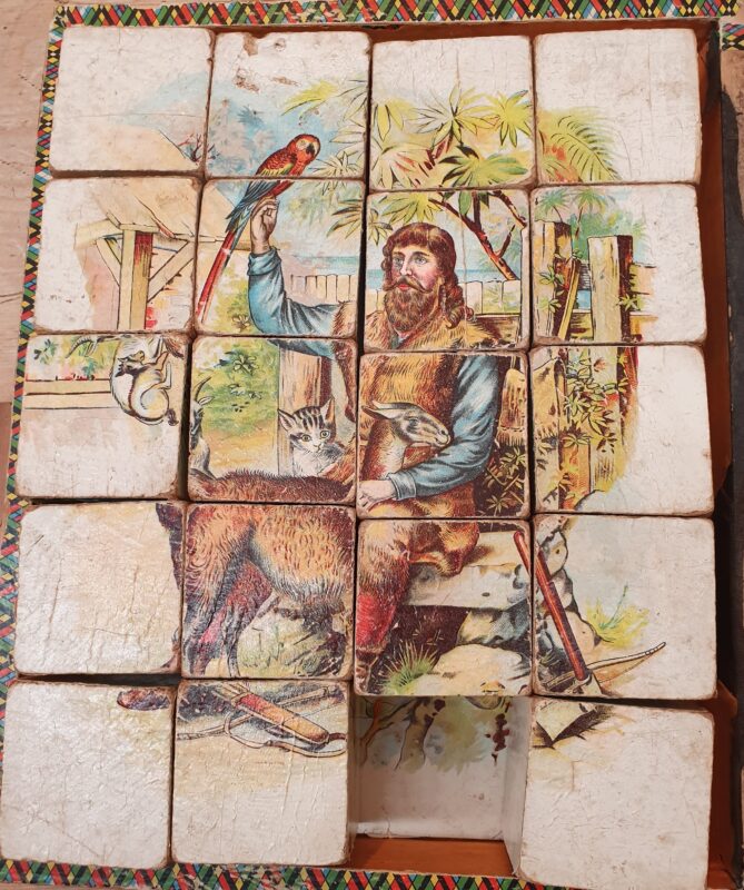 Robinson cube puzzle, depicting Robinson with a goat, a cat, and a parrot.